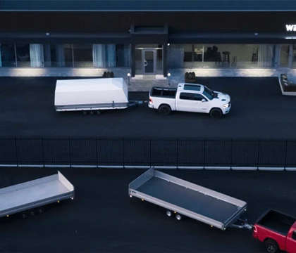 The image shows trucks with trailers parked outside a building labeled "WESTBAY".
